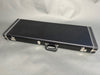 Black rectangular hard guitar case with silver latches and handle on gray background