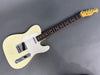 Vintage white Fender Telecaster electric guitar with rosewood fretboard and maple neck on gray background