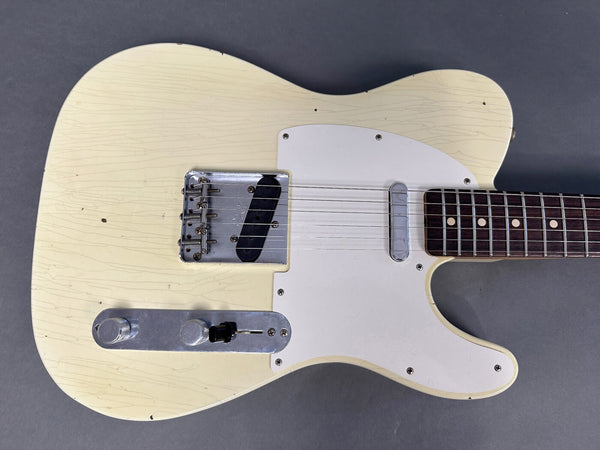 Vintage cream-colored electric guitar with white pickguard and rosewood fretboard on gray background