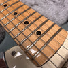 Close-up of maple fretboard with black dot inlays and steel guitar strings on electric guitar neck from Coffee House Guitars