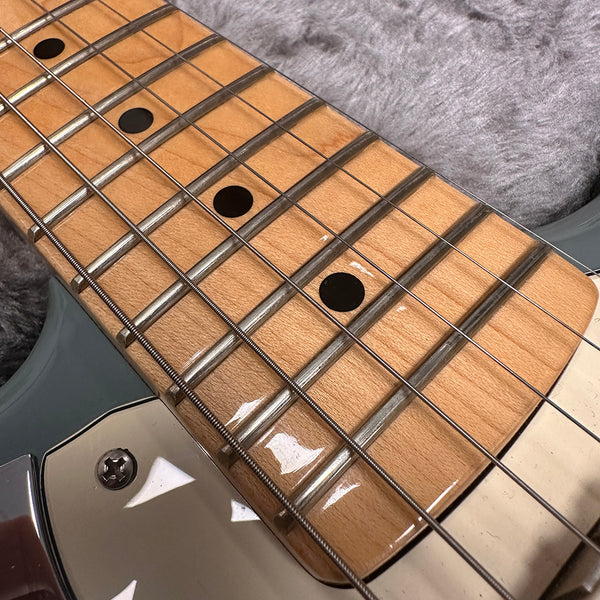 Close-up of maple fretboard with black dot inlays and steel guitar strings on electric guitar neck from Coffee House Guitars