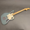 Fender Jaguar electric guitar with maple neck and grey finish on gray background, full body view