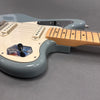 Close-up of light blue electric guitar body with white pickguard and maple neck on gray background, Coffee House Guitars product listing