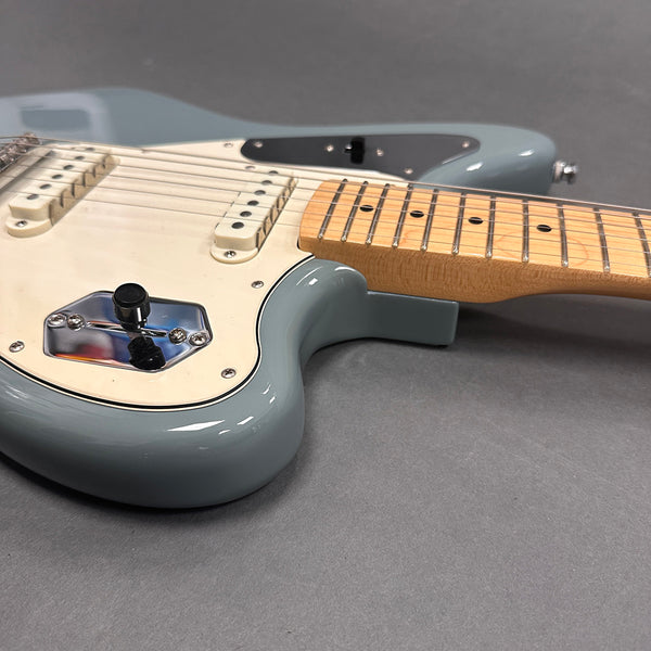 Close-up of light blue electric guitar body with white pickguard and maple neck on gray background, Coffee House Guitars product listing