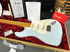 Fender Led Z Stratocaster thin electric guitar in light blue with maple neck resting in a red velvet lined tweed hard case, accompanied by Fender Certificate of Authenticity, pre-sales checklist, and owner's manual.