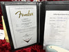 Fender Certificate of Authenticity for Ltd 57 Stratocaster Jm model with serial number CZ554028 and Coffee House Guitars pre-sale inspection checklist for Fender guitar maintenance tasks.