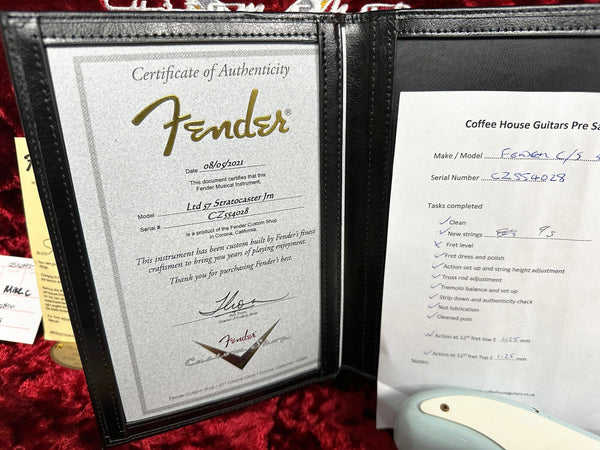 Fender Certificate of Authenticity for Ltd 57 Stratocaster Jm model with serial number CZ554028 and Coffee House Guitars pre-sale inspection checklist for Fender guitar maintenance tasks.