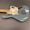 Seafoam green Fender electric guitar with maple neck and dual single-coil pickups on gray background