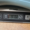 Digital scale showing weight of 9 pounds 0.2 ounces on Dymo brand scale for Coffee House Guitars product weighing.