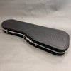 Black Yamaha hard shell guitar case with silver latches and handle on gray background