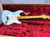 Fender Stratocaster electric guitar in light blue finish with maple neck and vintage-style white pickguard inside red plush-lined custom shop case