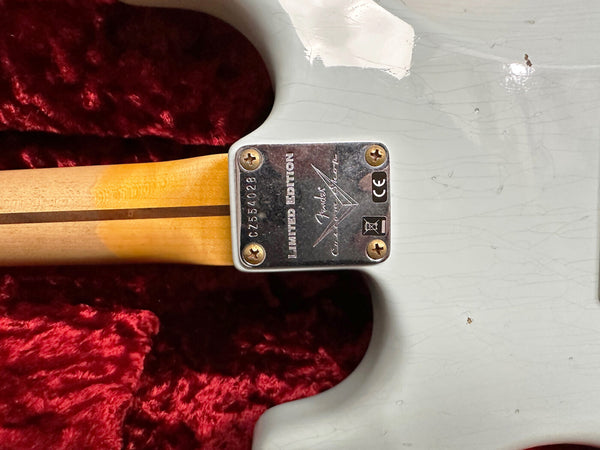 Close-up of Fender Custom Shop Limited Edition electric guitar neck plate and maple neck on white guitar body with visible wear and scratches