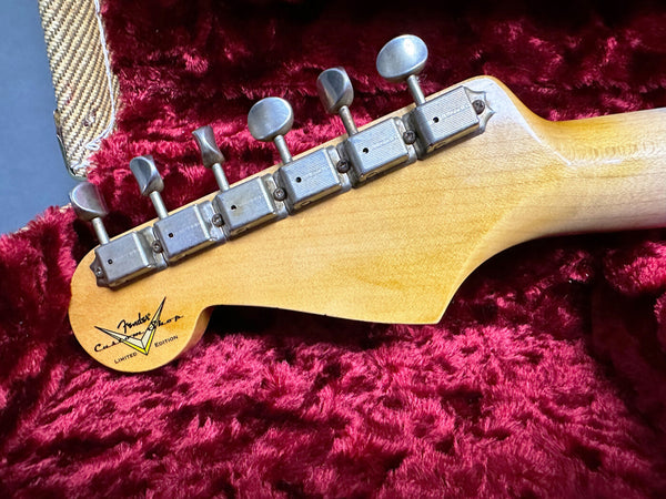 Vintage Fender Custom Shop Limited Edition guitar headstock with vintage tuning machines on red plush case lining