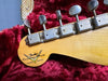 Close-up of vintage Fender Custom Shop Limited Edition guitar headstock with six vintage tuning pegs on red plush guitar case interior