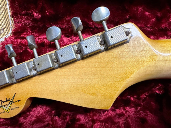 Close-up of vintage Fender Lone Star Limited Edition guitar headstock with Luzon tuning pegs on plush red guitar case lining