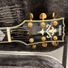 Yamaha Custom SG 3000 electric guitar headstock with gold tuning pegs and decorative inlay on black background