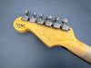 Vintage Fender Custom Shop limited edition guitar headstock with six tuning pegs and natural wood finish on grey background
