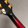 Close-up of Yamaha guitar neck and headstock showing tuning pegs and serial number made in Japan, glossy black to red sunburst finish guitar neck.