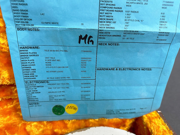 Close-up of a guitar spec sheet detailing hardware and electronics including Tele 58-63 bridge, vintage Tele output, 56/57 Tele neck and bridge pickups, Present Day Tele controls, Olympic White body finish, and 63 Tele pickguard, on a blue sheet inside an orange plush guitar case.