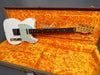 Vintage Fender Telecaster electric guitar with worn white finish and mint green pickguard in orange plush-lined Fender Custom Shop hard case