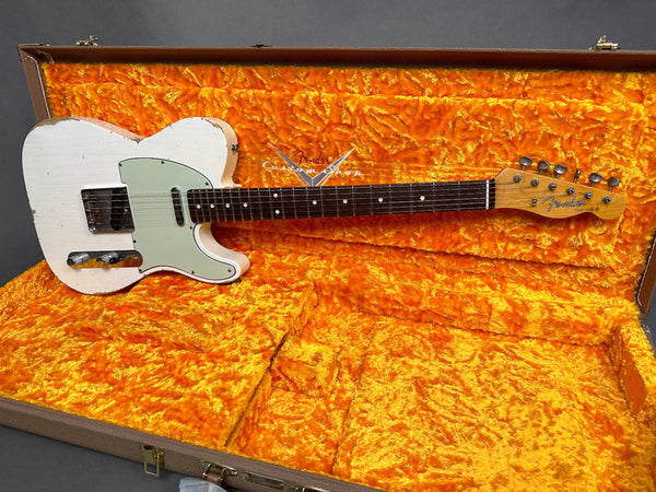 Vintage Fender Telecaster electric guitar with worn white finish and mint green pickguard in orange plush-lined Fender Custom Shop hard case