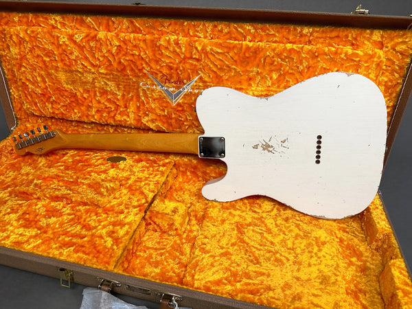 White vintage Fender Telecaster guitar with worn finish in orange plush-lined Fender Custom Shop hard case showing back and neck detail