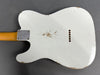 White relic electric guitar body with visible wear and vintage finish, maple neck plate close-up on gray background