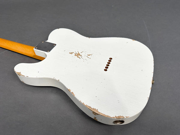 Back view of white electric guitar body with worn and chipped paint, showing string ferrules and neck joint on gray background