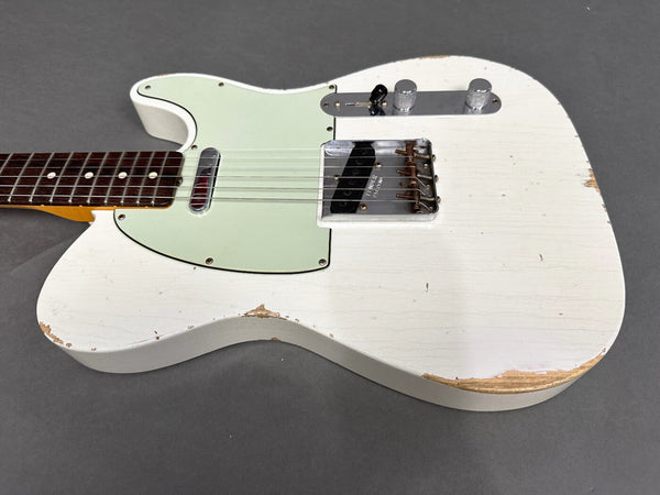 Close-up of white electric guitar body with distressed finish, rosewood fretboard, mint green pickguard, and metal bridge with two control knobs on gray background for Coffee House Guitars product listing.