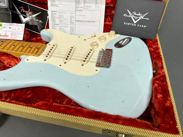 Fender Custom Shop light blue electric guitar with maple neck and vintage white pickguard in red plush-lined tweed case with Fender Custom Care papers and certificates.