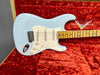 Light blue Fender Stratocaster electric guitar with maple neck and vintage white pickguard in red velvet-lined Fender Custom Shop guitar case
