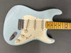Light blue vintage-style electric guitar with cream pickguard and maple fretboard, showing aged finish and wear marks, perfect for classic rock and blues players.