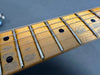 Close-up of worn maple guitar neck and fretboard with metal frets and black dot inlays from Coffee House Guitars