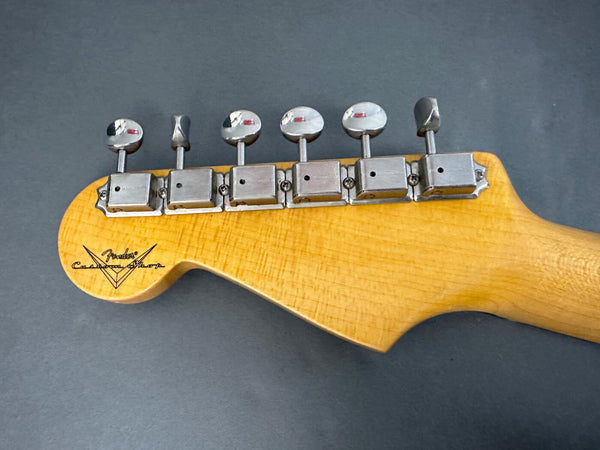 Close-up of vintage Fender Custom Shop guitar headstock with six tuning pegs and maple wood finish