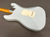 Vintage electric guitar back body in worn white finish with cream tremolo cover plate and maple neck with skunk stripe