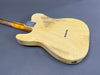Vintage yellow telecaster-style electric guitar body back with worn finish and maple neck on gray background