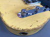 Close-up of vintage cream electric guitar body with worn paint and chrome control knobs at Coffee House Guitars