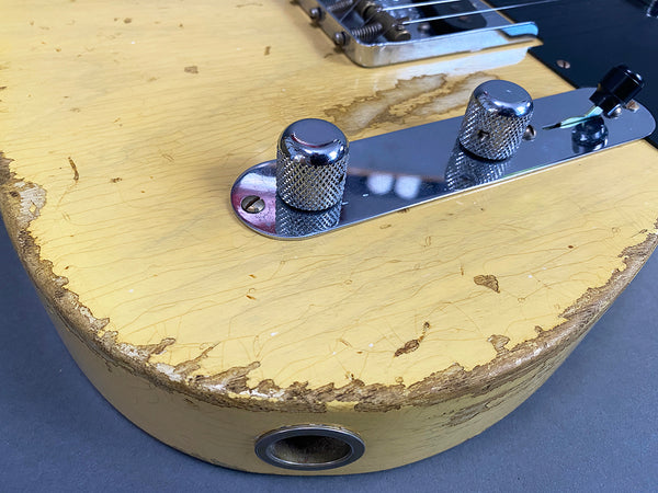 Close-up of vintage cream electric guitar body with worn paint and chrome control knobs at Coffee House Guitars