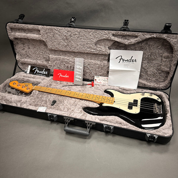 Fender electric bass guitar with maple neck and black body in plush lined hard case with Fender manuals and accessories