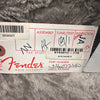 Fender guitar box label with part number 0193612-776 and serial number SS16073680, showing assembly, tune/test, and inspector signatures on a gray fabric background.