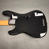 Back of black Fender electric guitar with maple neck and chrome Fender neck plate on gray background