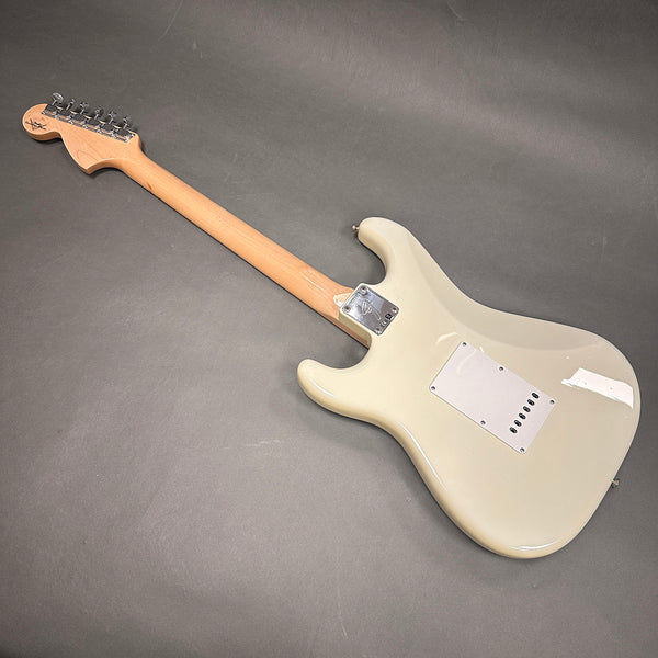 White electric guitar back view showing maple neck and chrome tuning pegs on gray background