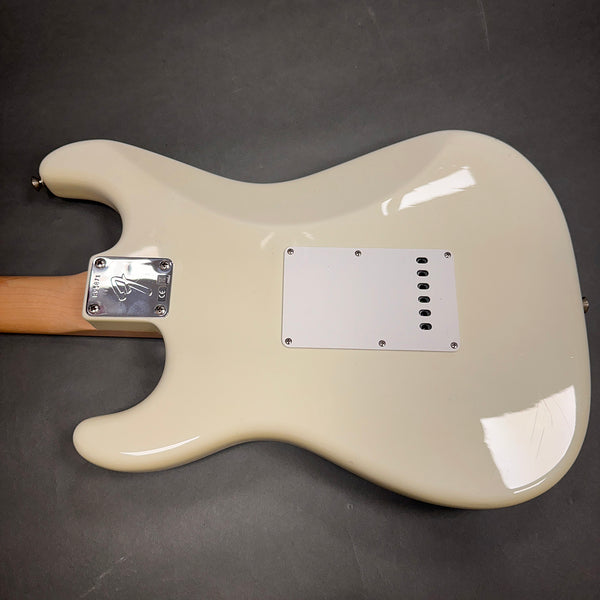 White electric guitar body back view showing neck plate with Fender logo and string cavity cover plate on gray background
