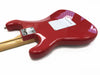 Glossy red electric guitar body with natural wood neck and white backplate on white background, showing rear view with chrome neck plate and string ferrules