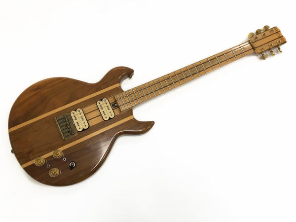 Vintage electric guitar with natural wood finish and dual humbucker pickups on white background