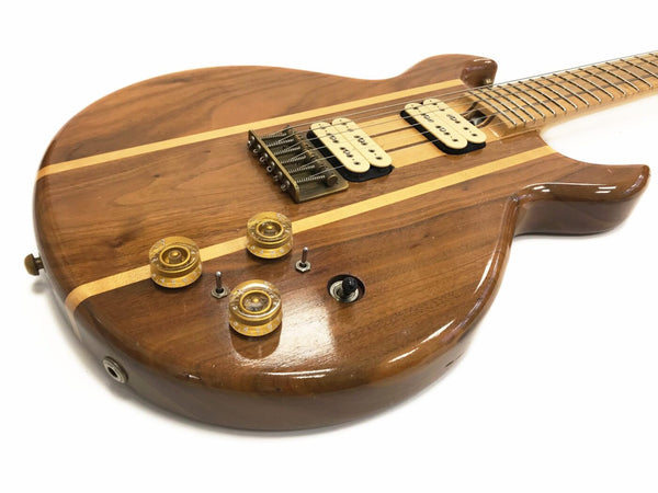 Natural wood finish electric guitar body with dual cream humbucker pickups and clear amber control knobs