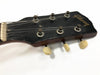 Close-up of vintage Gibson guitar headstock with six tuning pegs and black finish showing wear and patina on metal hardware and wooden edges