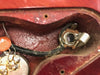 Close-up view of vintage electric guitar internal wiring showing potentiometer and input jack cavity with cloth-covered wire and capacitor component
