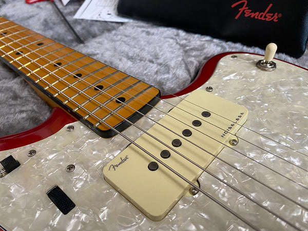 Close-up of Fender Noise-less single-coil pickups and maple fretboard on red electric guitar with pearloid pickguard at Coffee House Guitars
