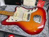 Fender electric guitar with sunburst finish and pearl white pickguard in gray plush-lined hard case with Fender manuals and tags